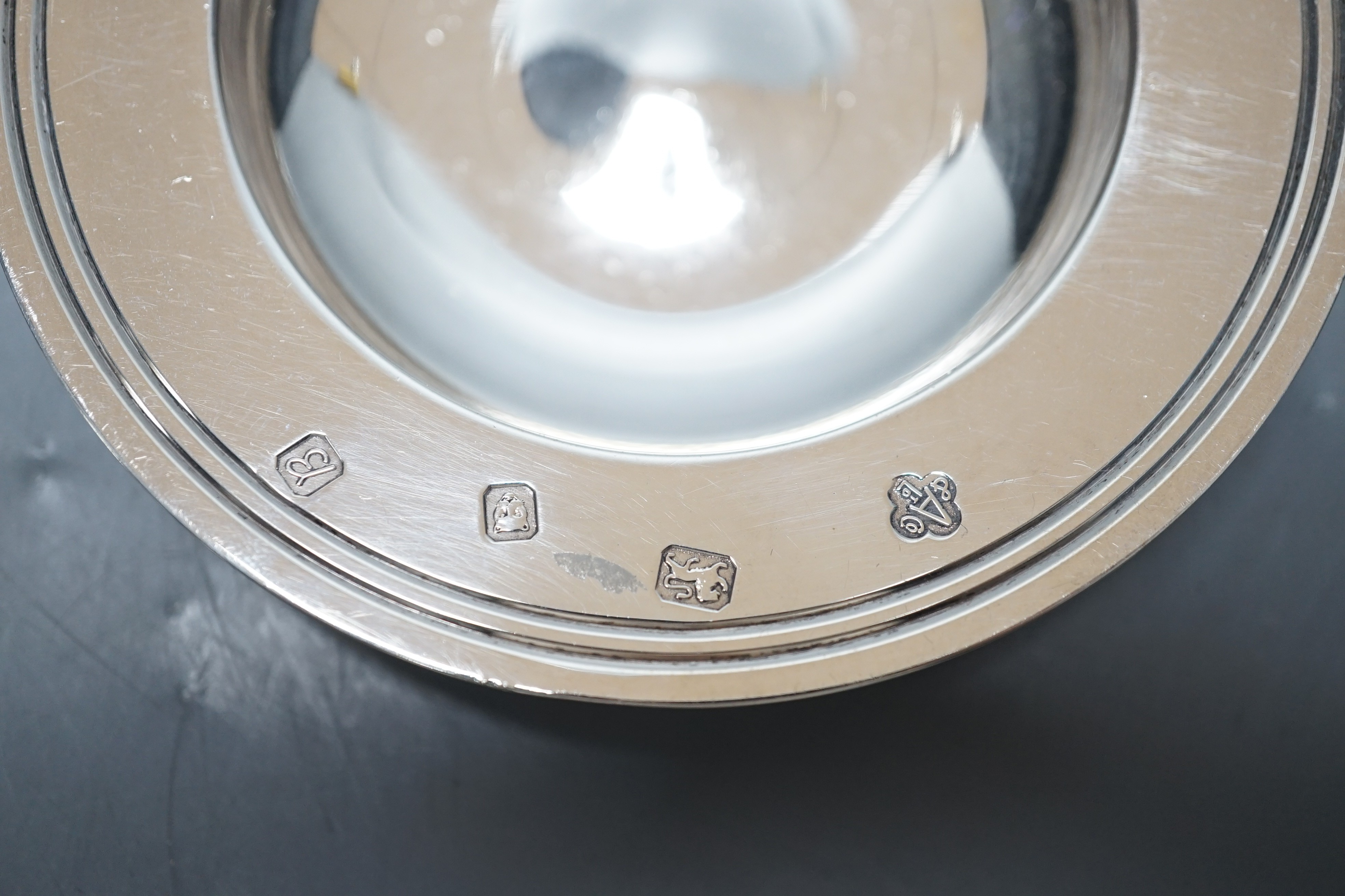 A George V silver ashtray, Mappin & Webb, Sheffield, 1928, 13cm, a modern Asprey & Co small dish and a continental white metal box and cover, gross 12.2oz.